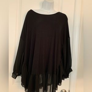 Black top with sheer sleeves and sheer bottom fringe